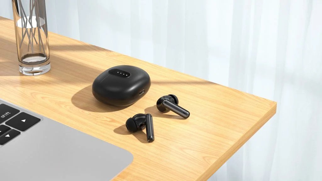 Wireless earbuds in an open charging case next to a smartphone